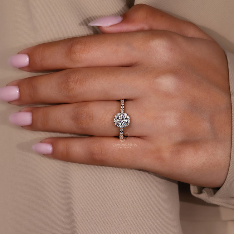 Elegant round halo setting with gold band and lab diamonds.
