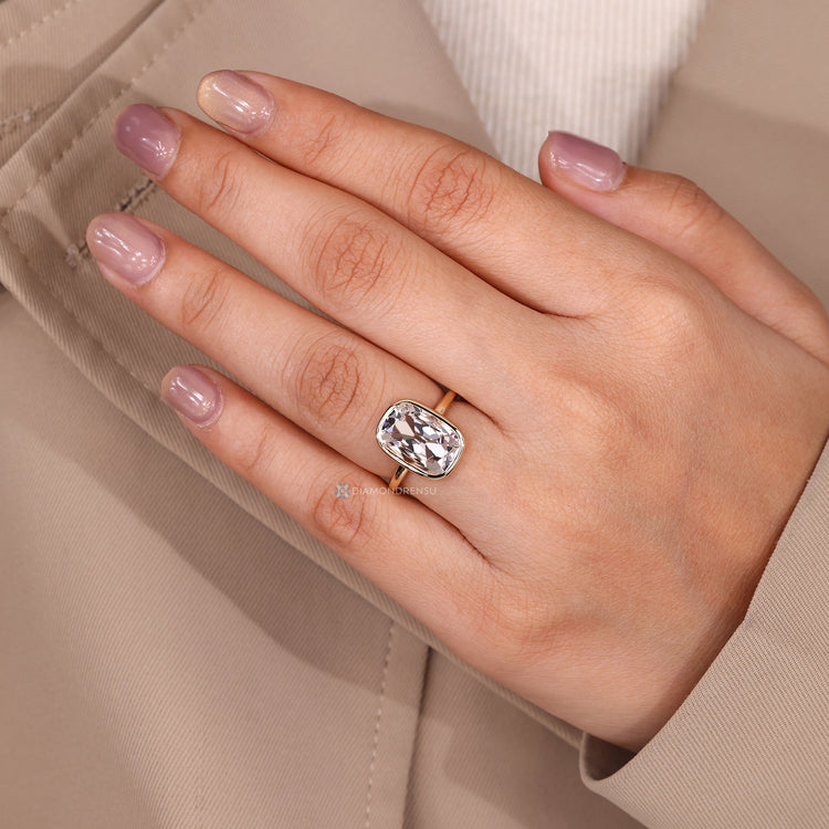 Cushion old European cut solitaire bezel ring.