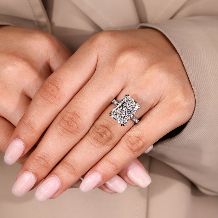 Radiant cut diamond ring with double claw prong setting.