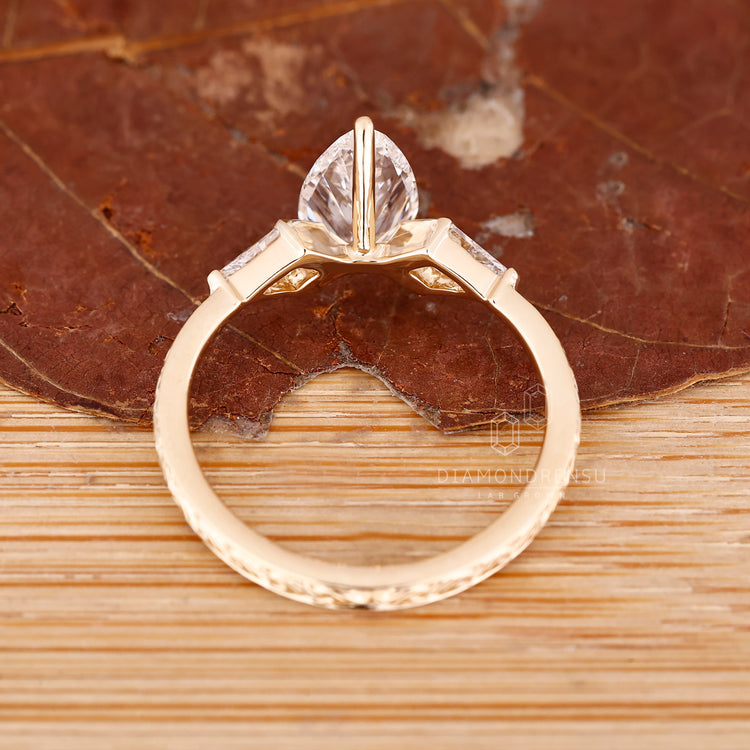 IGI certified pear diamond ring tapered shank style.