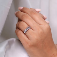 Emerald cut ring six stone shared prong half eternity.
