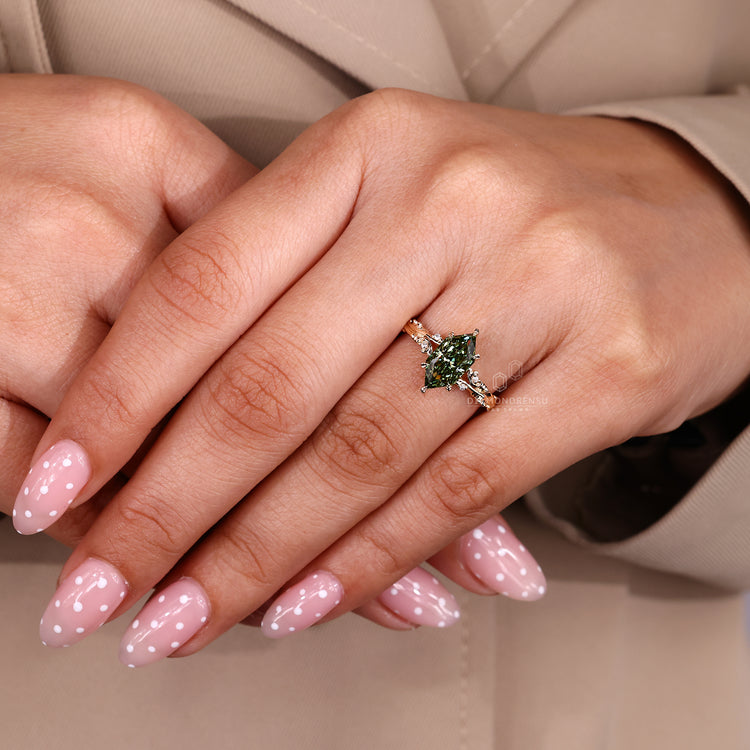 Green diamond ring with handcrafted round side stone details.