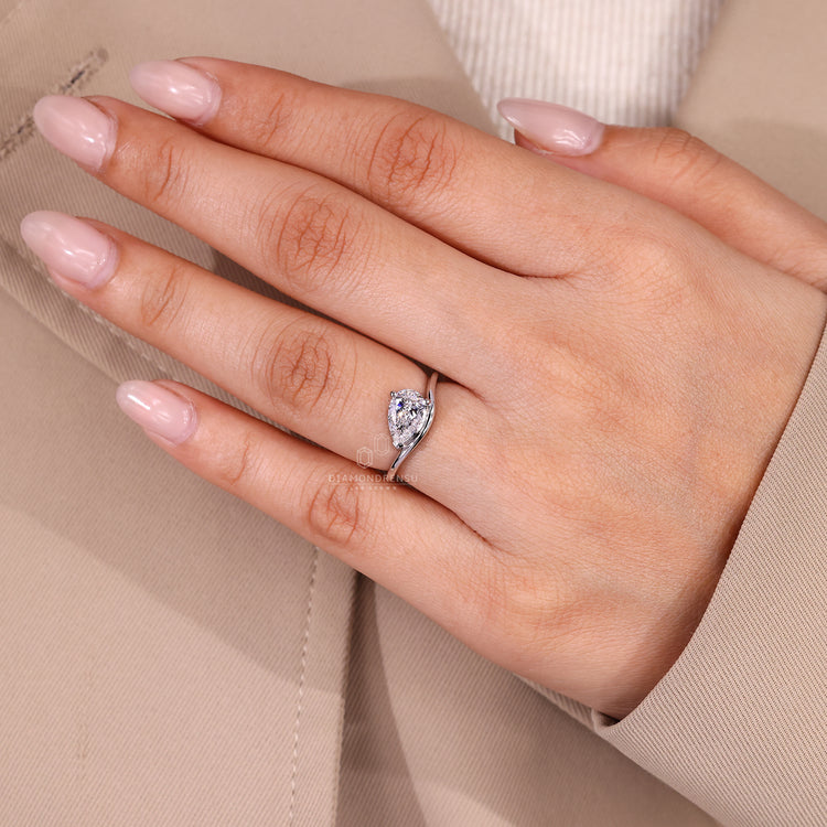 Solitaire pear diamond ring with V prong detail.
