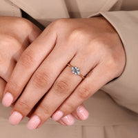 Lab grown diamond round ring with side stone accents.
