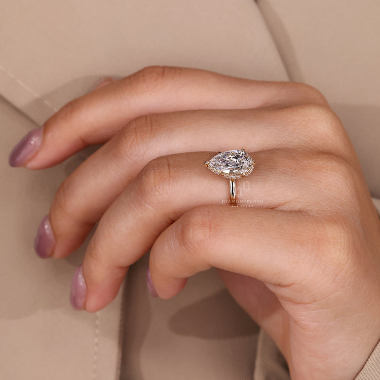 Elegant hidden halo pear diamond engagement ring.
