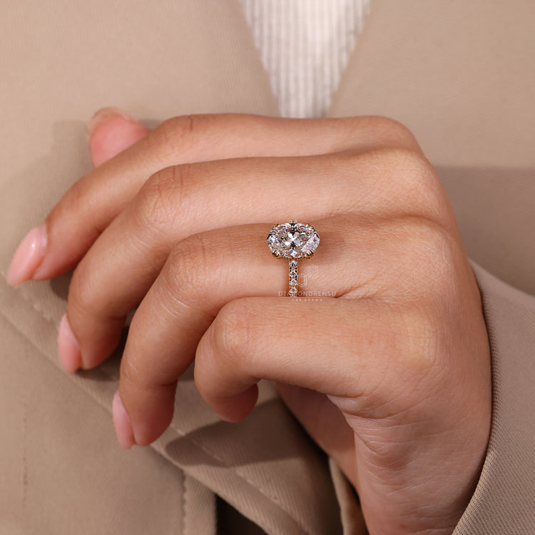 Oval cut centre stone ring with round diamond pave.
