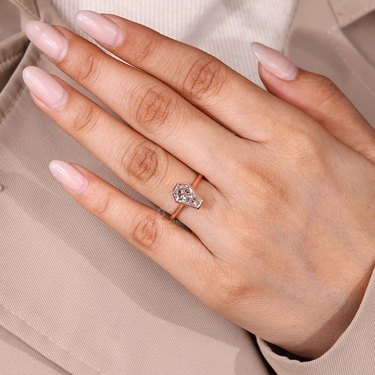 Coffin cut diamond ring cathedral bezel style.