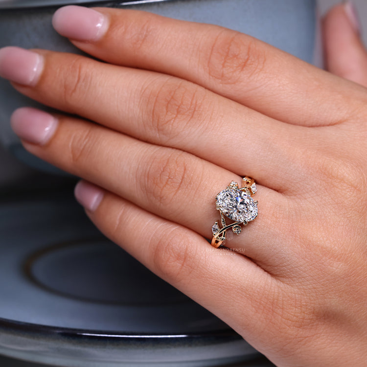 Oval cut ring marquise round stones leaf prong set.
