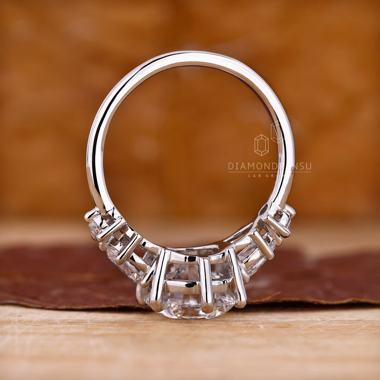 Lab grown round diamond ring with pear sides.
