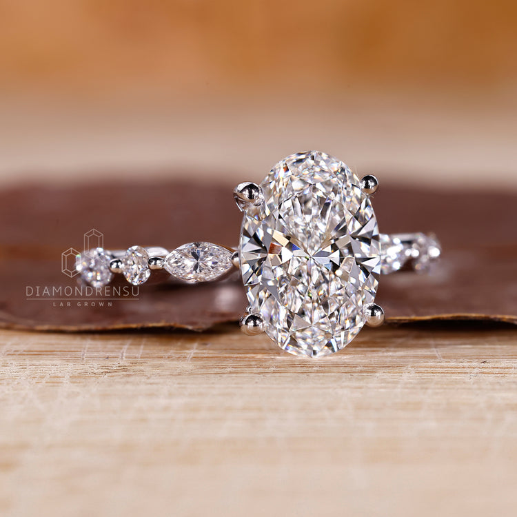 Shared prong setting suits marquise and round side stone.
