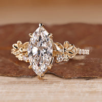 Marquise diamond ring six claw prong pave round stone.
