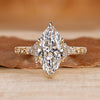 Marquise diamond ring with round side stones.