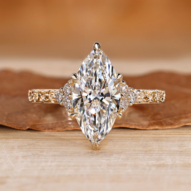 Marquise diamond ring with round side stones.