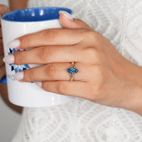 Blue marquise diamond ring with leaf style prongs.