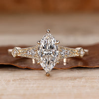 Marquise cut diamond ring vintage round side stones.