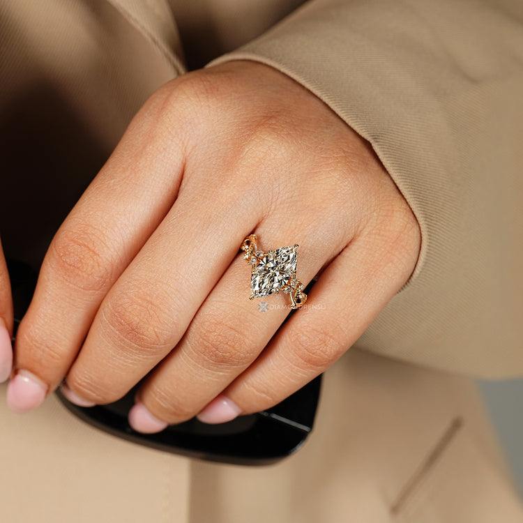 Marquise ring with cluster setting and side stones.