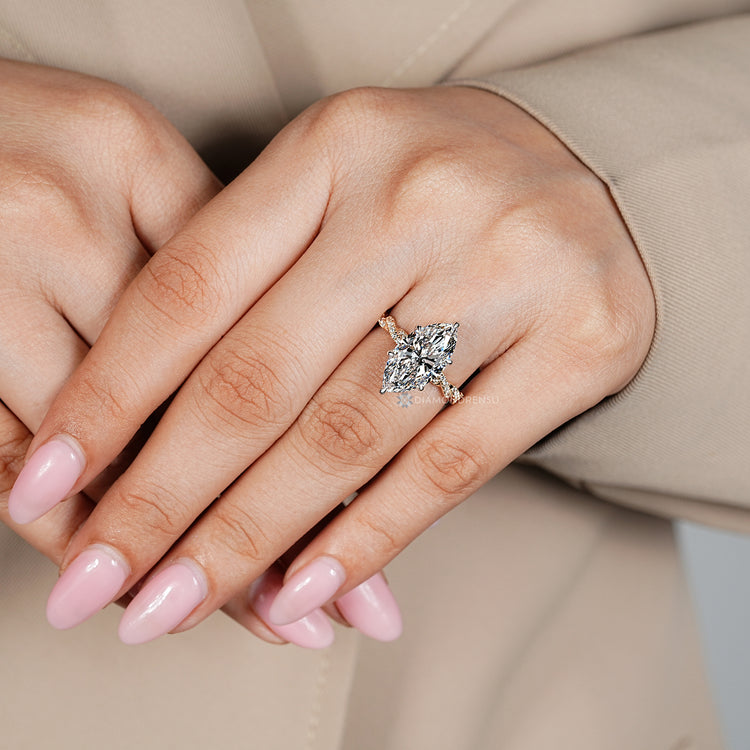 Handmade marquise diamond ring with round diamond pavé.
