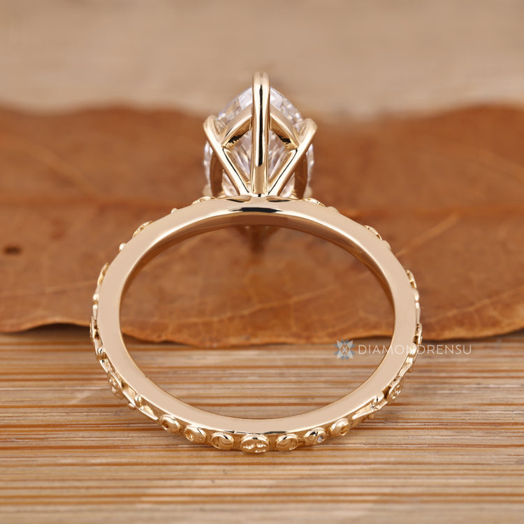 Handmade marquise diamond ring with leaf style prongs.
