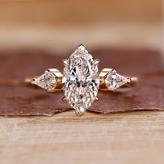 Three stone diamond ring with marquise centre stone.
