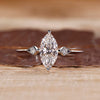 Marquise diamond ring round side stones three stone.
