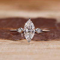 Marquise diamond ring round side stones three stone.

