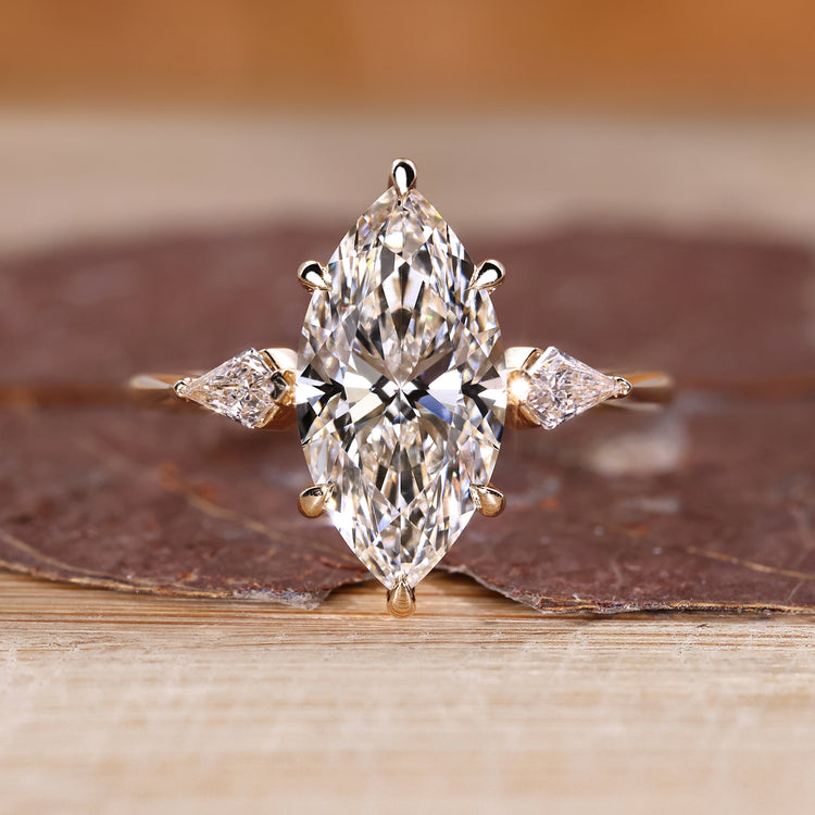Marquise diamond engagement ring with hidden halo design.