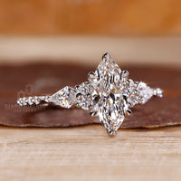 Marquise ring round kite stones tapered shank style.
