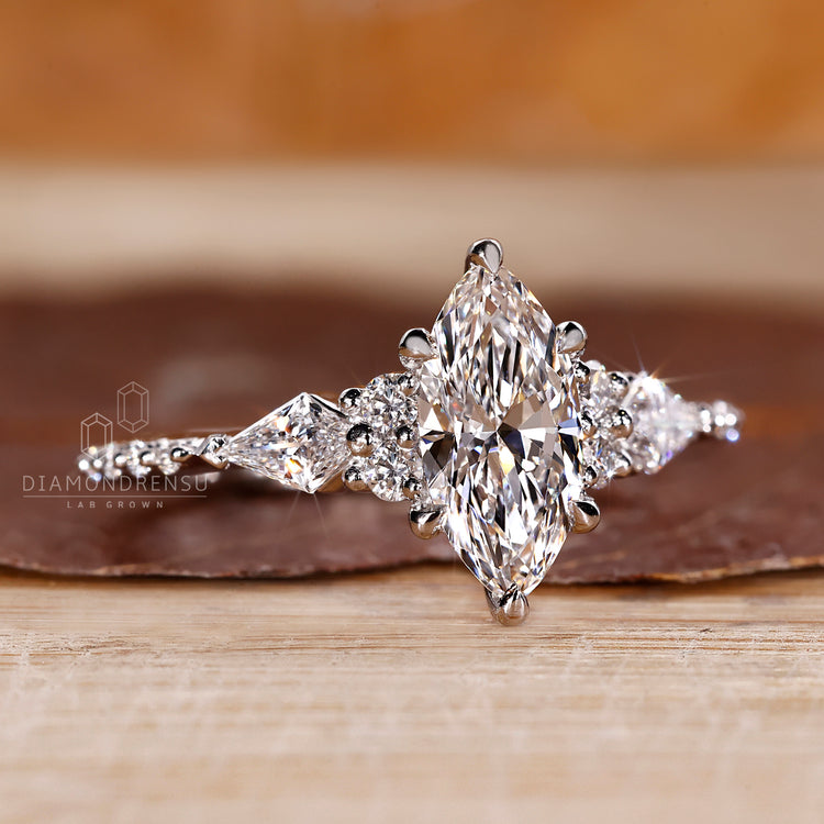 Marquise ring round kite stones tapered shank style.

