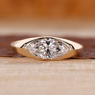 Flush diamond engagement ring with marquise diamond centre.
