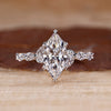 Nature inspired engagement ring with marquise cut diamond centre.

