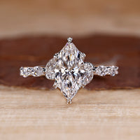 Nature inspired engagement ring with marquise cut diamond centre.
