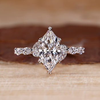 Nature inspired engagement ring with marquise cut diamond centre.
