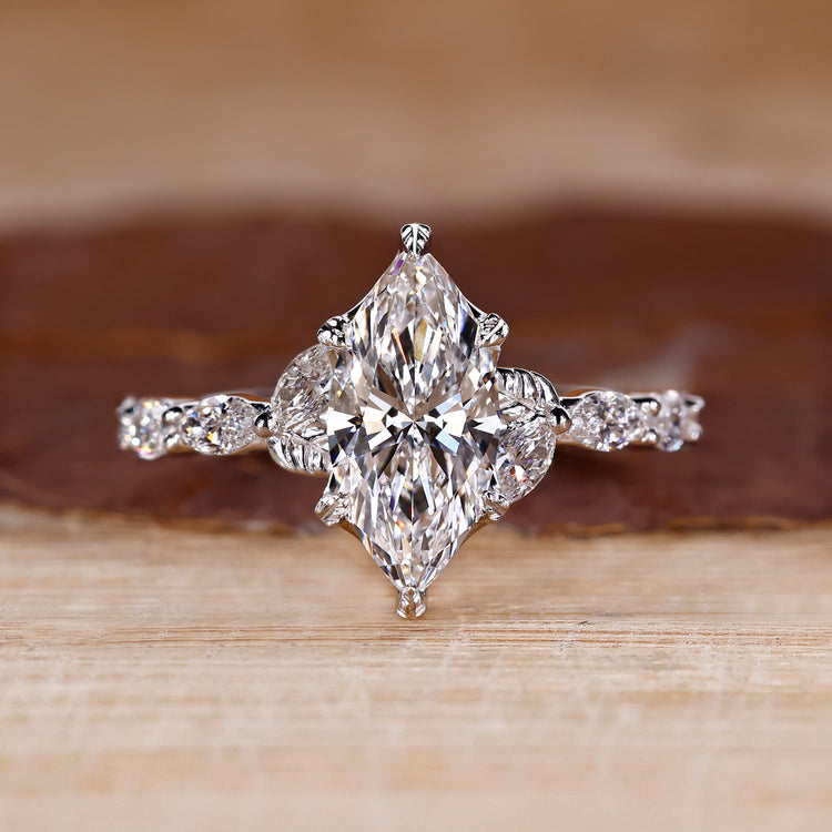 Nature inspired engagement ring with marquise cut diamond centre.
