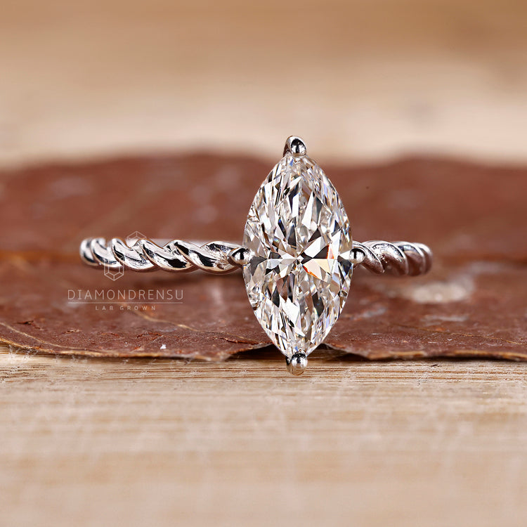 Solitaire marquise diamond ring compass prong set.
