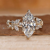 Marquise ring with round diamond cluster side stones.