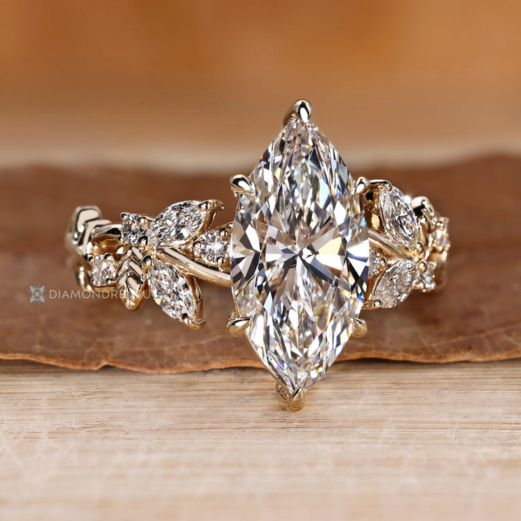 Marquise ring with round diamond cluster side stones.