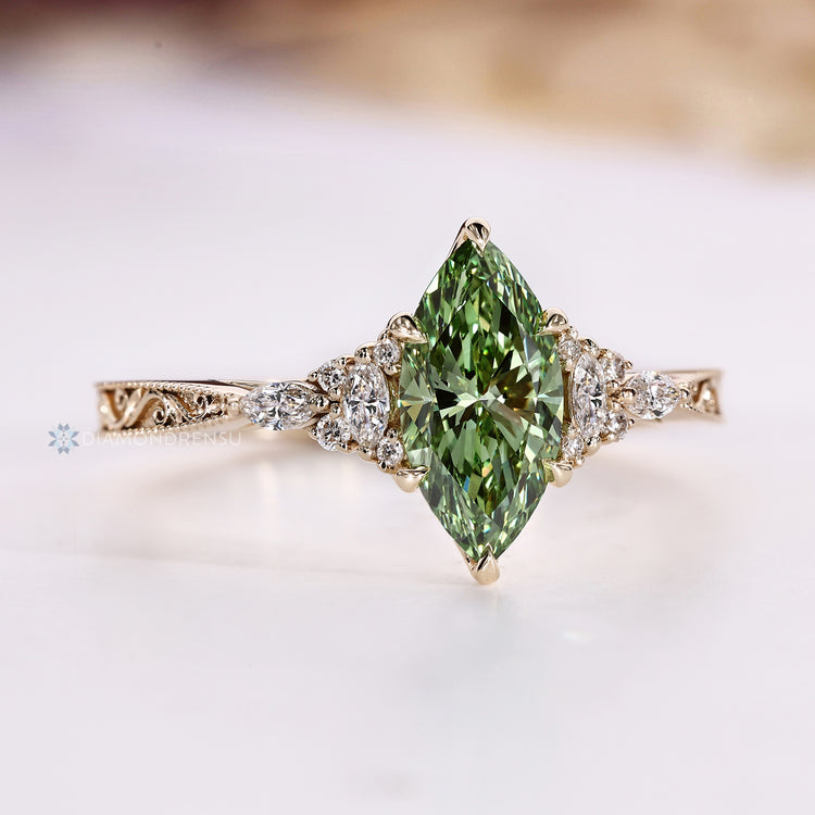 Green marquise diamond ring with tapered shank.