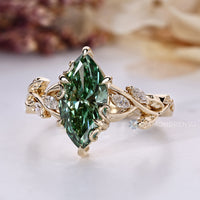 Green diamond ring with marquise side stones.