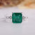 Asscher emerald ring hidden halo tapered shank style.
