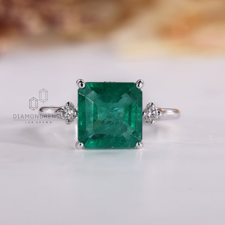 Asscher emerald ring hidden halo tapered shank style.
