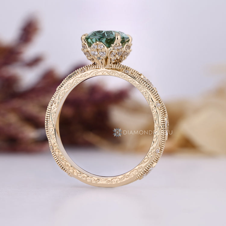 Oval diamond ring with milgrain and four claw prongs.