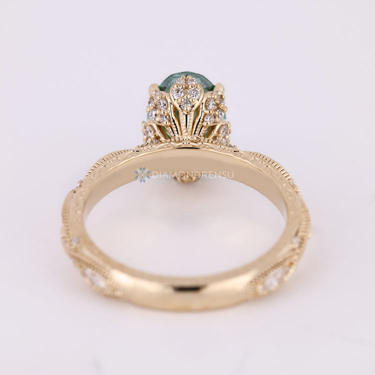 Diamondrensu AU oval diamond ring with green diamond.