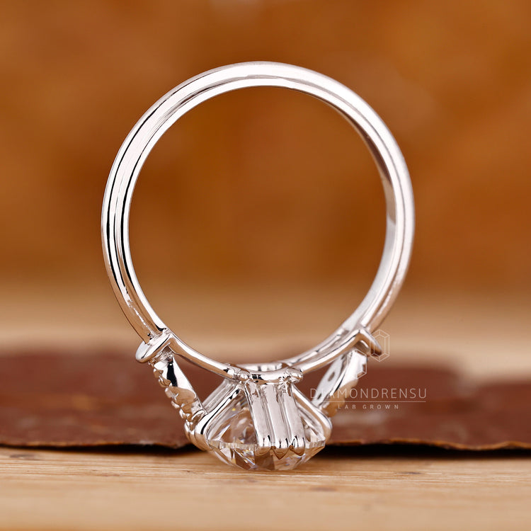 Round cut side stones Cushion Old European Cut Ring.
