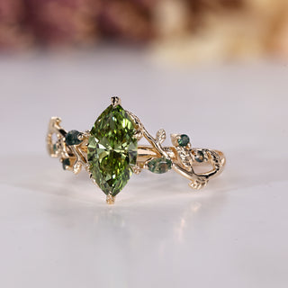 Marquise cut diamond ring with green diamond.