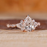Pear diamond ring pear round side stones cluster style.