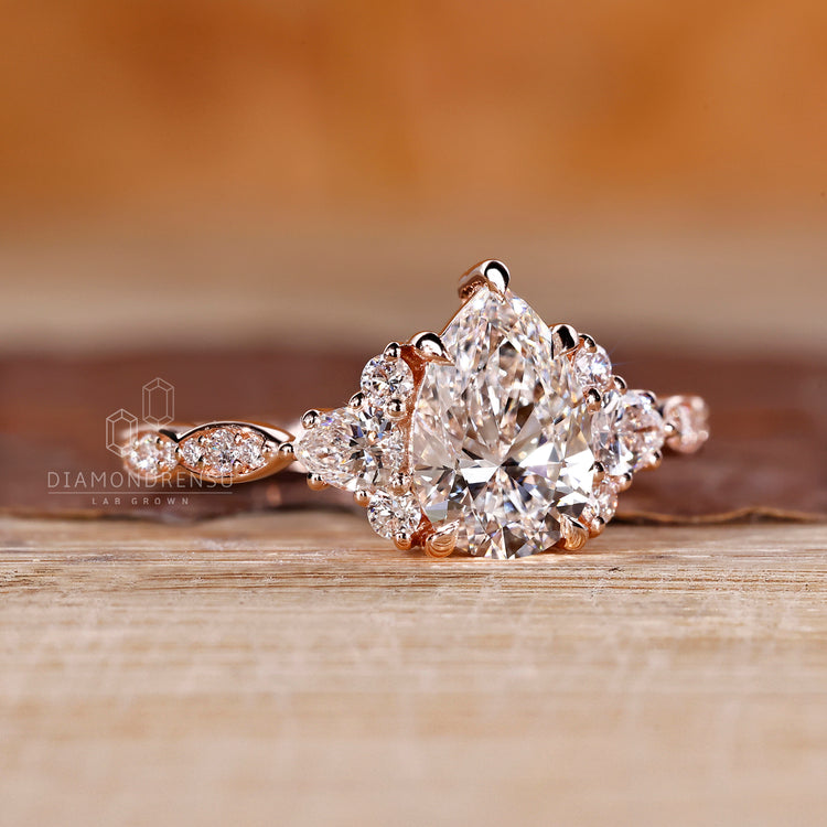 Pear diamond ring pear round side stones cluster style.