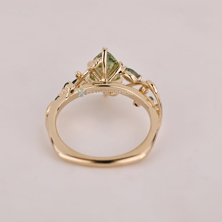 Marquise diamond ring with round moss agate side stones.