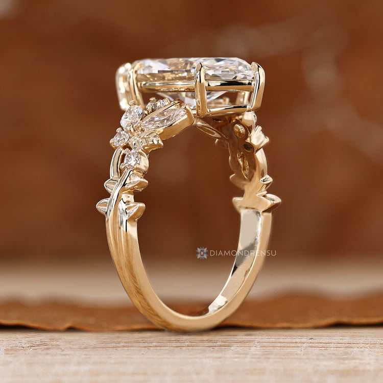 Marquise diamond ring with round side stones in clusters.