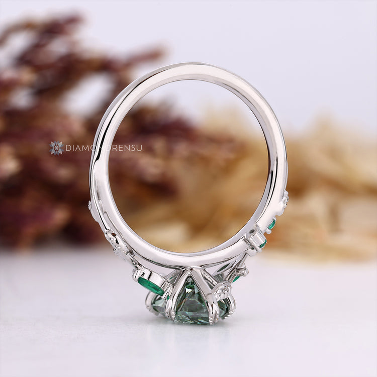 Lab grown Dutch marquise diamond ring with green emeralds.
