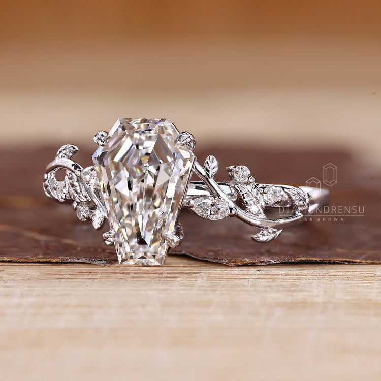 Coffin ring with a marquise and round stone cluster - pretty cool style.